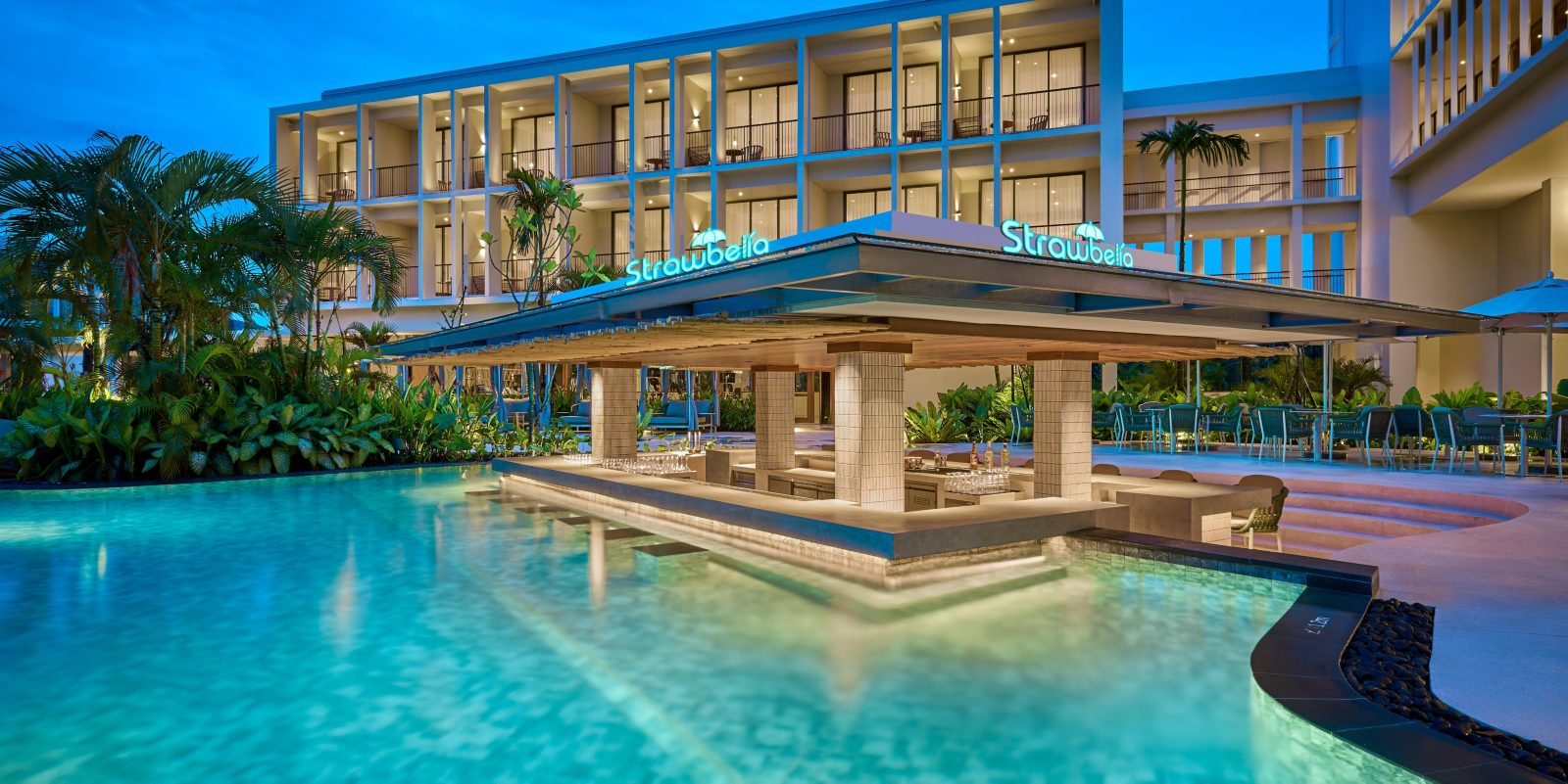Pool bar and guest rooms at Holiday Inn Resort Bintan Lagoi Beach at dusk
